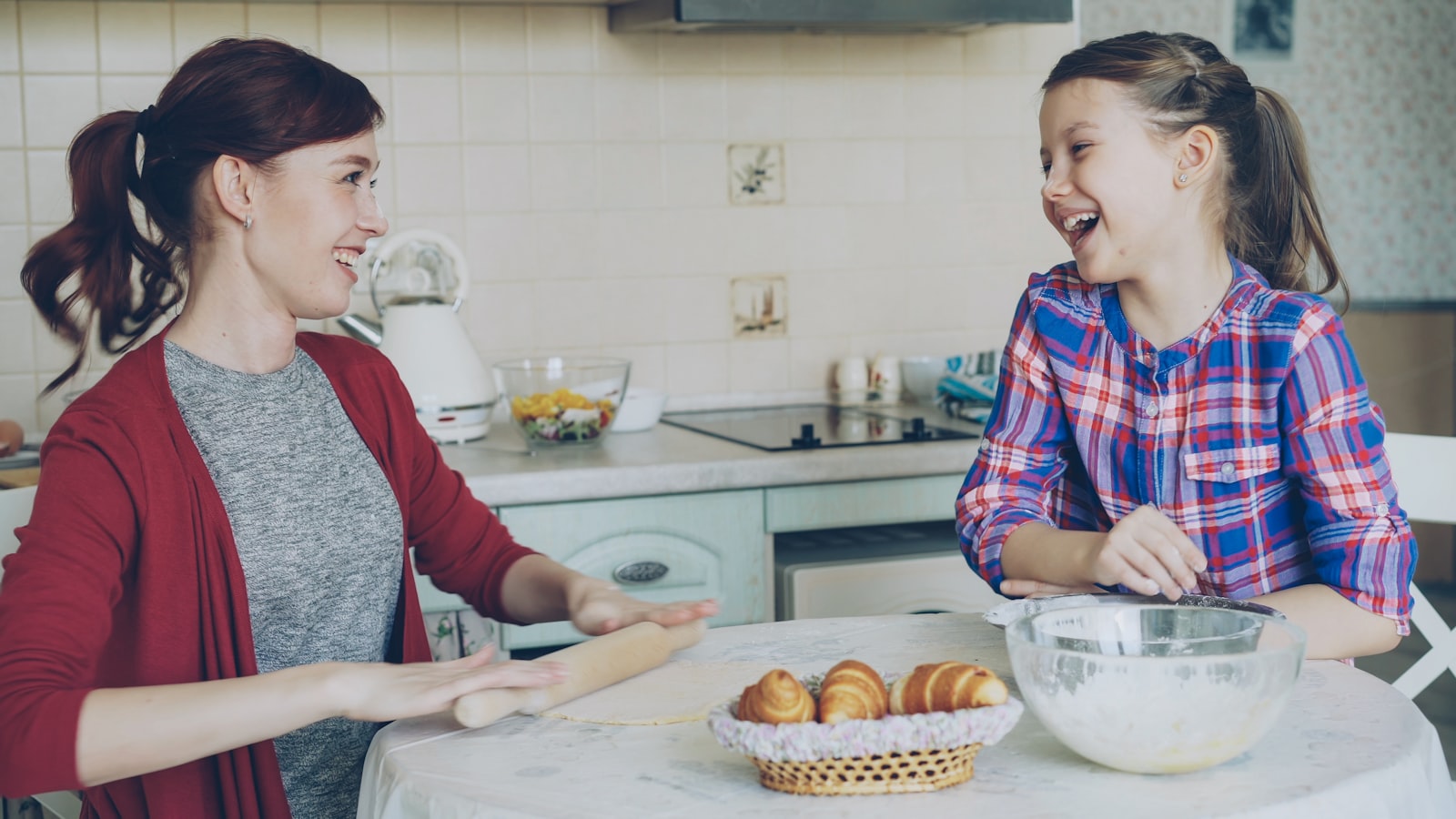 Mother and daughter baking together in a warm kitchen