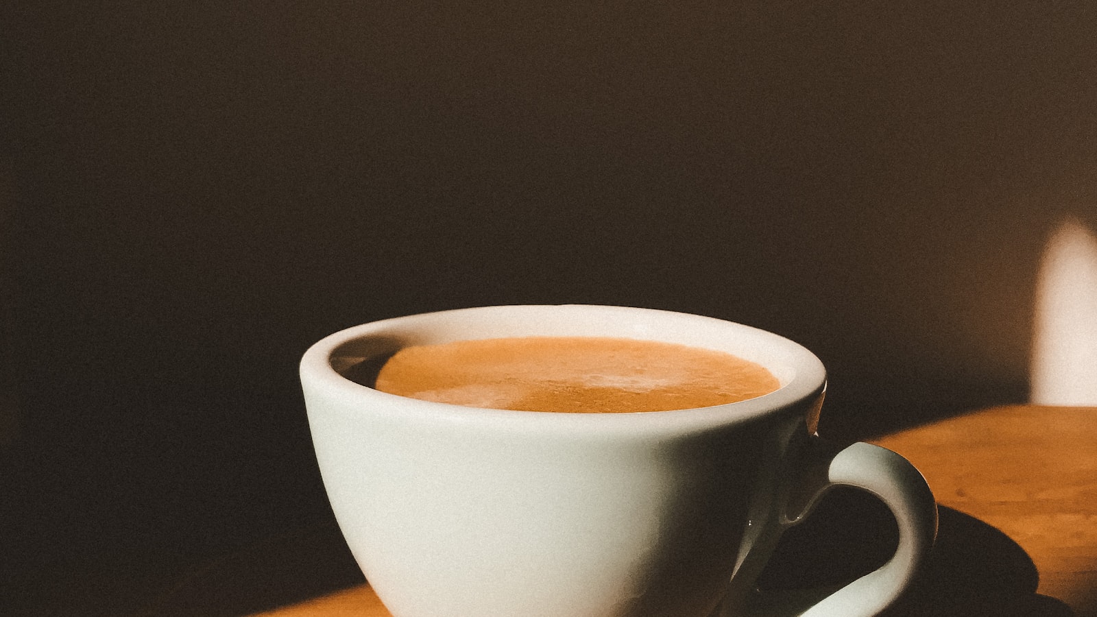Simple white coffee cup on a plain surface — skin in your thirties